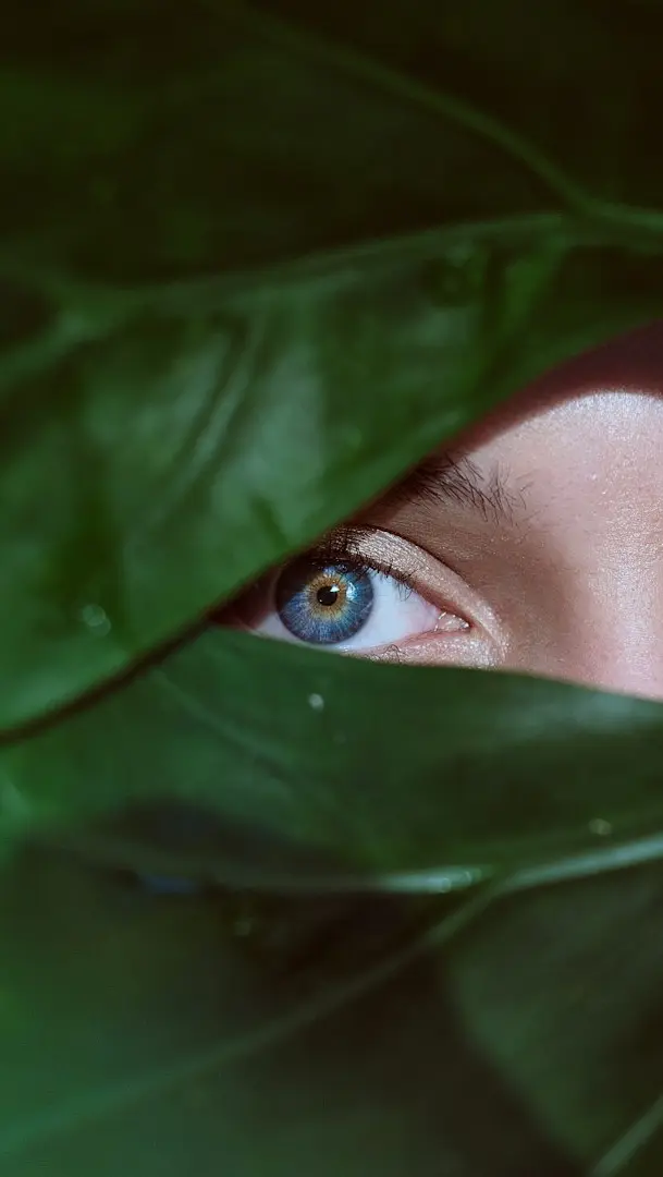 woman in green hijab covering her face with green textile